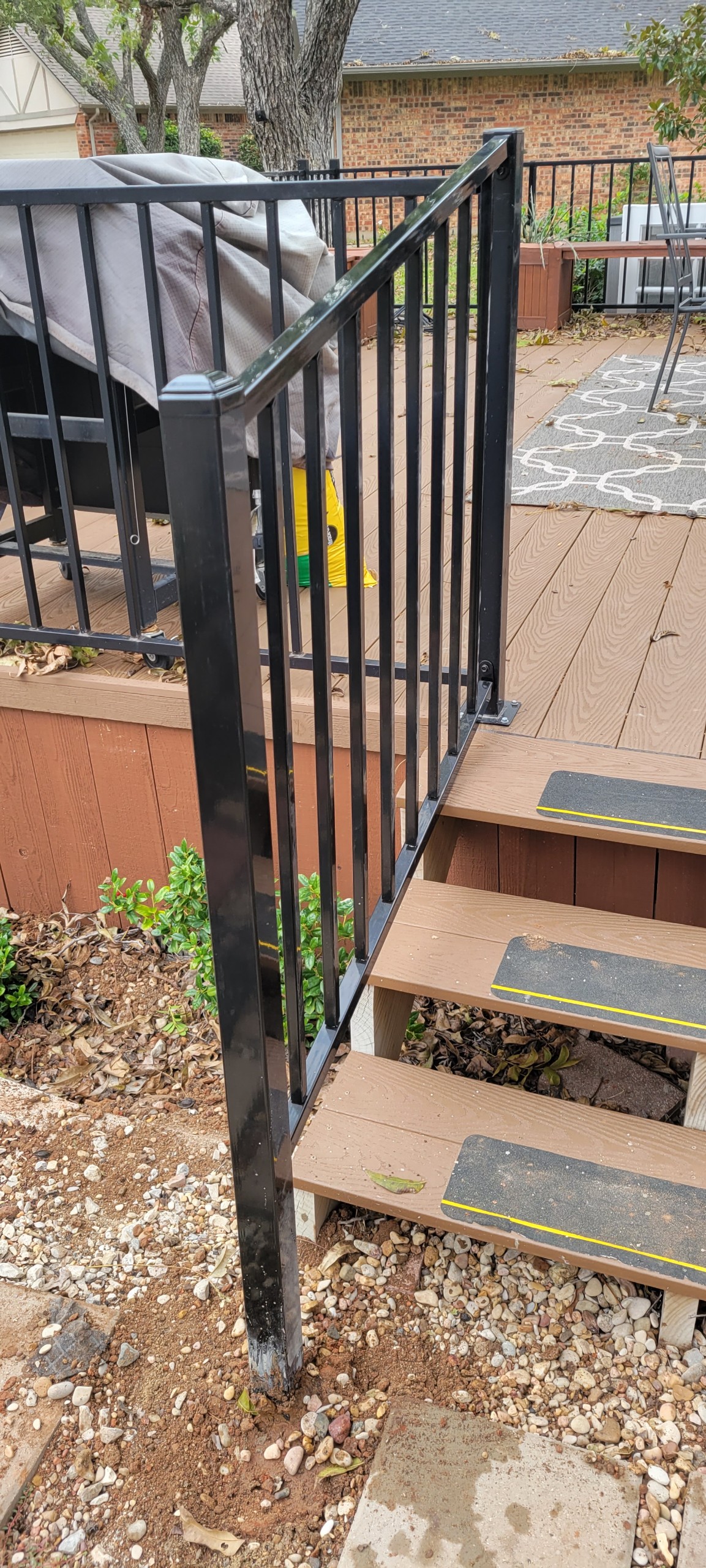 Black ornamental metal fence and railing installed along an outdoor staircase near Lake Granbury