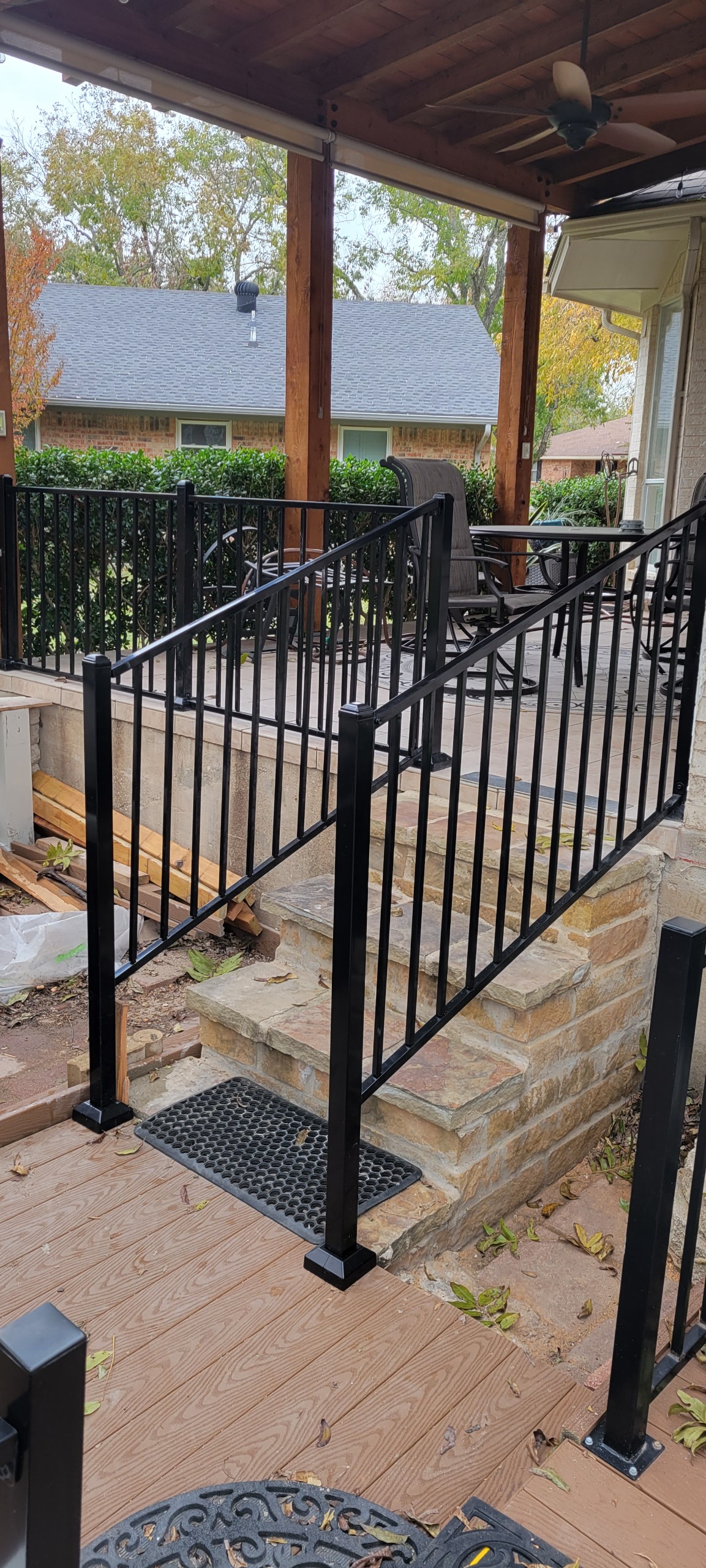 Freshly painted black metal pipe railing on an outdoor staircase, the kind of clean finish the Flexi Pipe Painter delivers