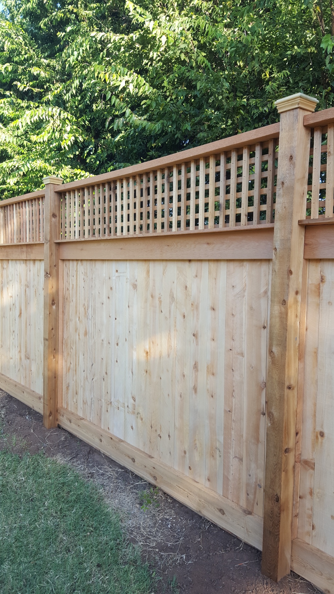 Cedar wood privacy fence with a decorative lattice top installed by All Around Fencing near Granbury, TX
